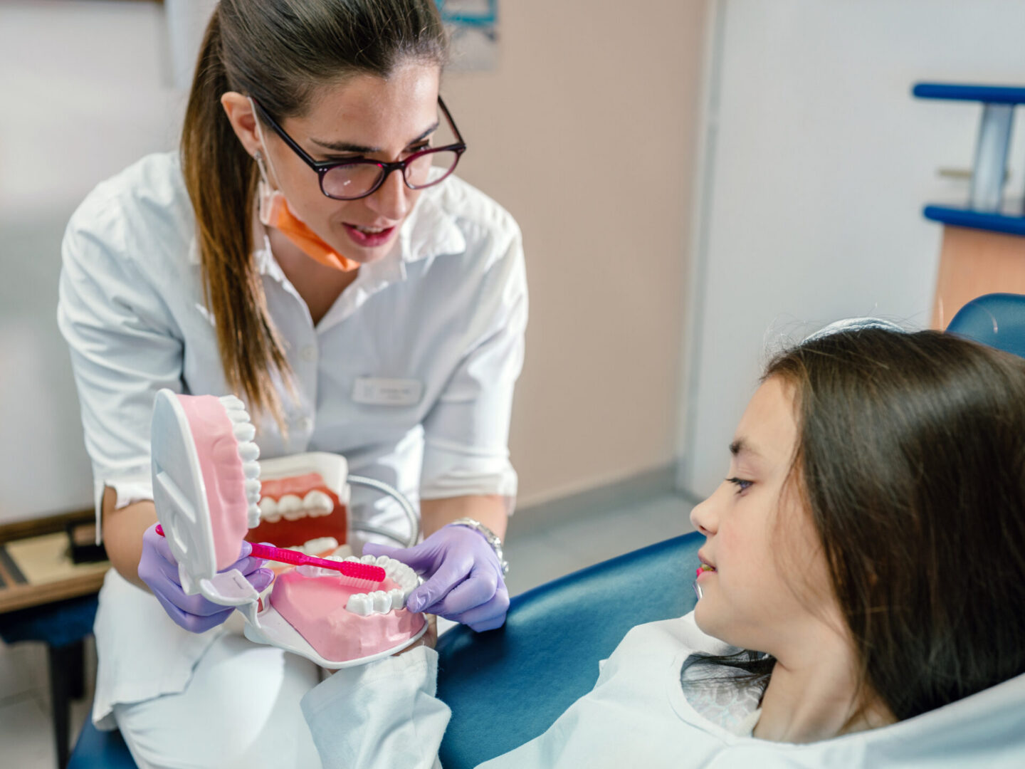 Dentist explaining oral care to young patient