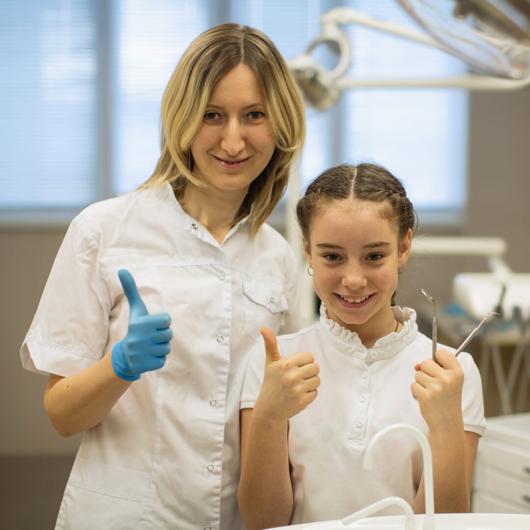 Dentist and child smiling in clinic