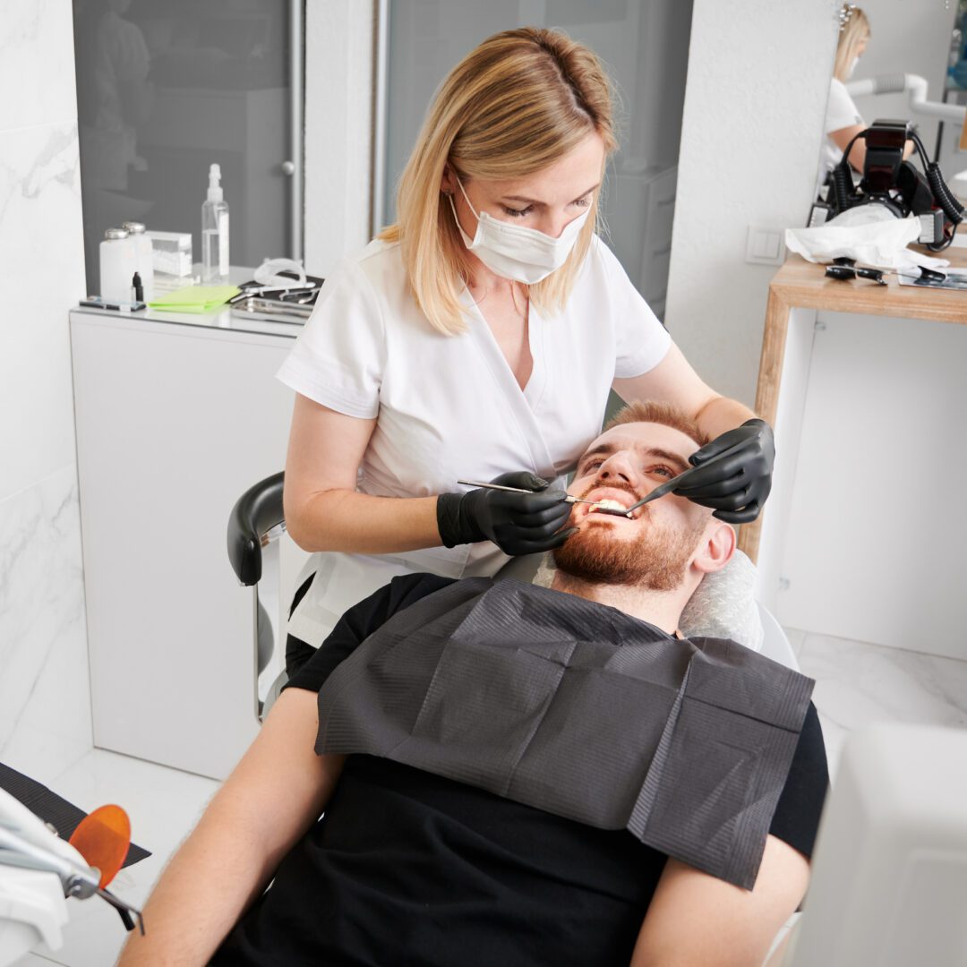Dentist examining patient's teeth
