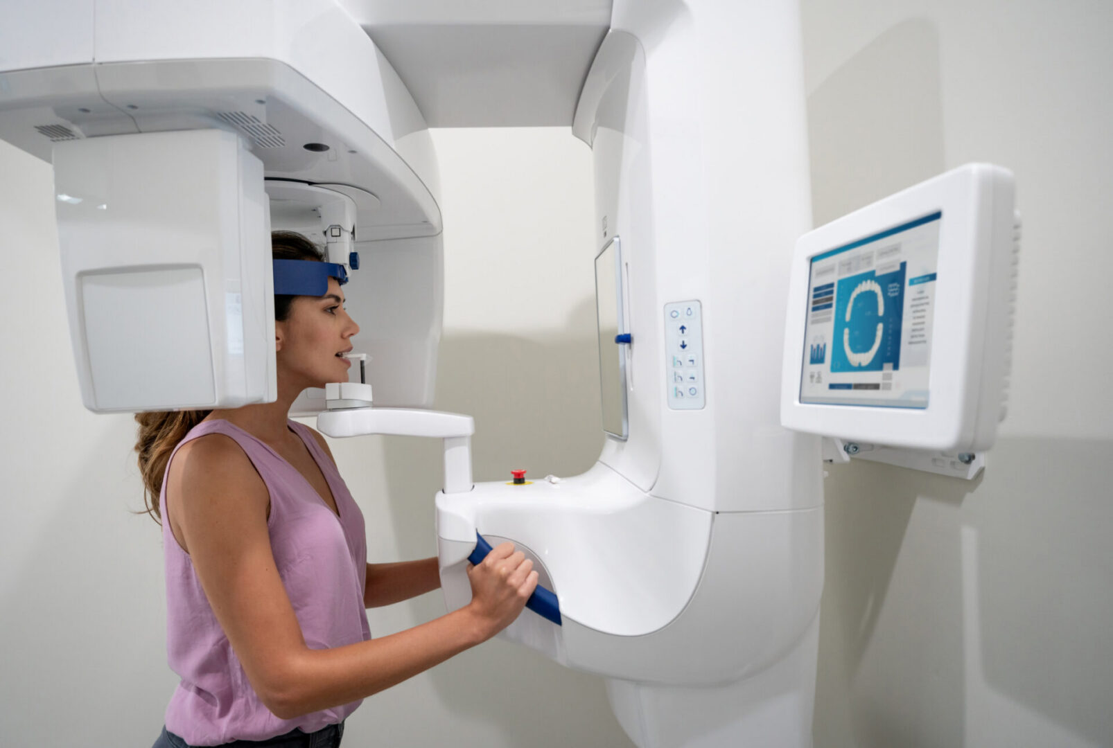 Woman using dental imaging machine