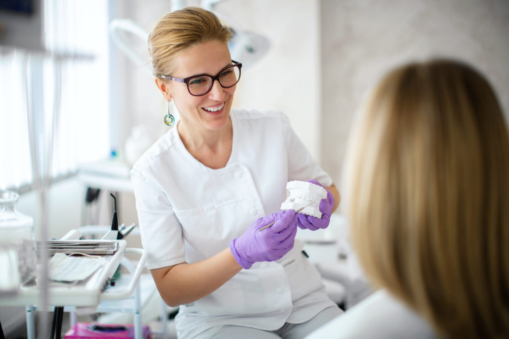 Dentist explaining dental model to patient