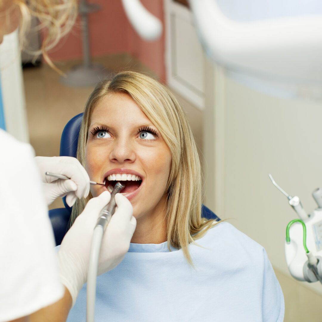 Dentist examining patient's teeth