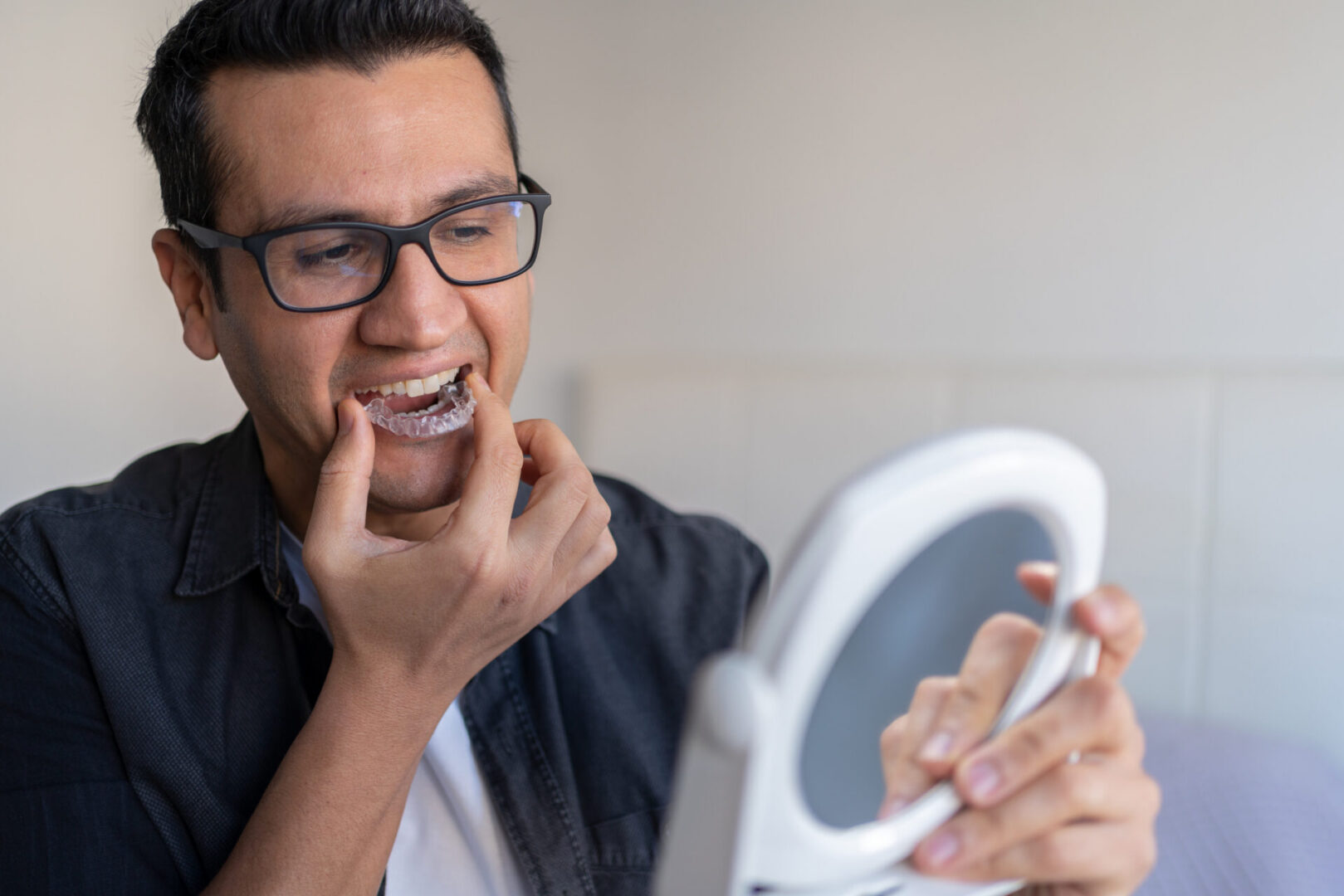 Person using clear aligner for teeth
