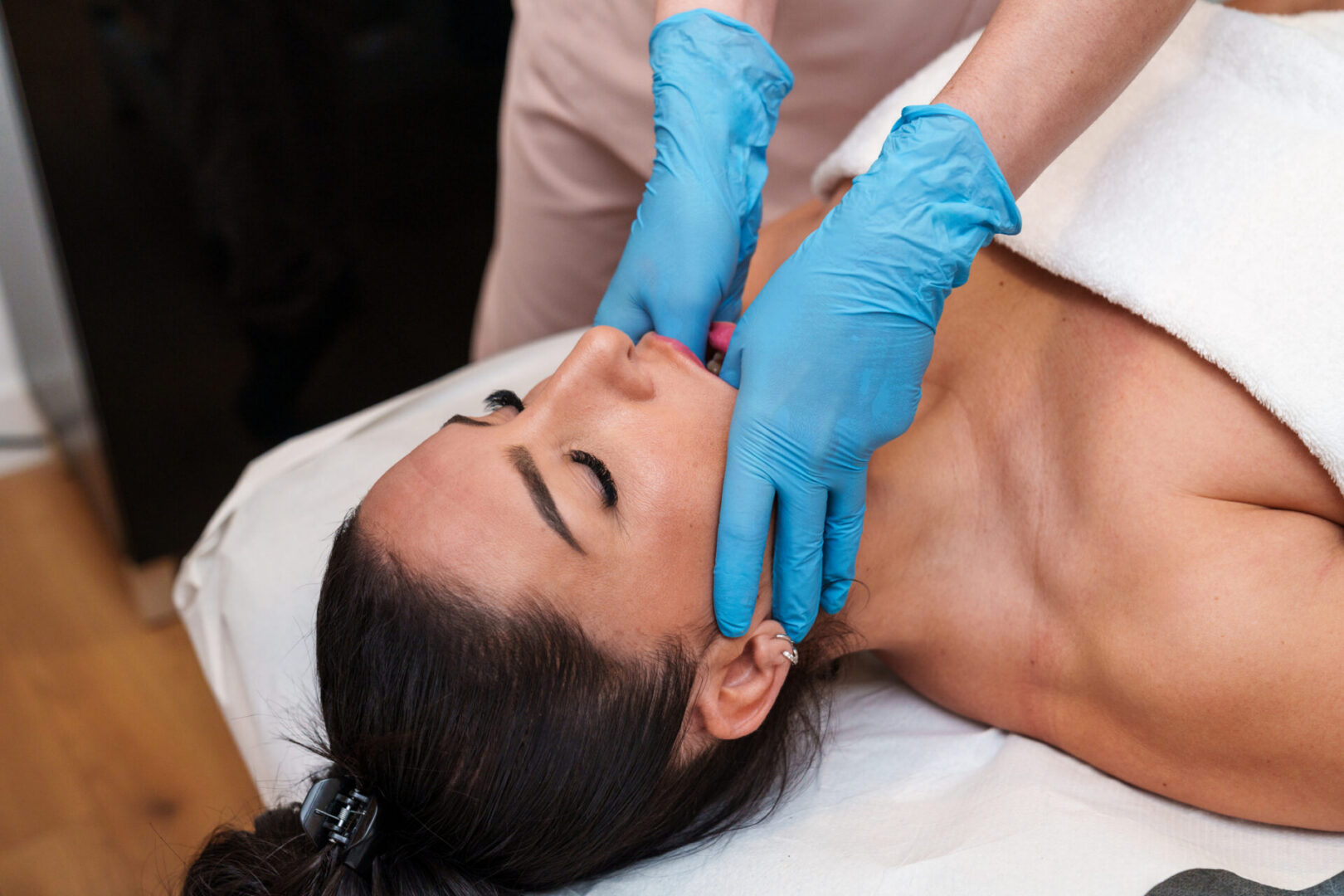 Facial massage with blue gloves