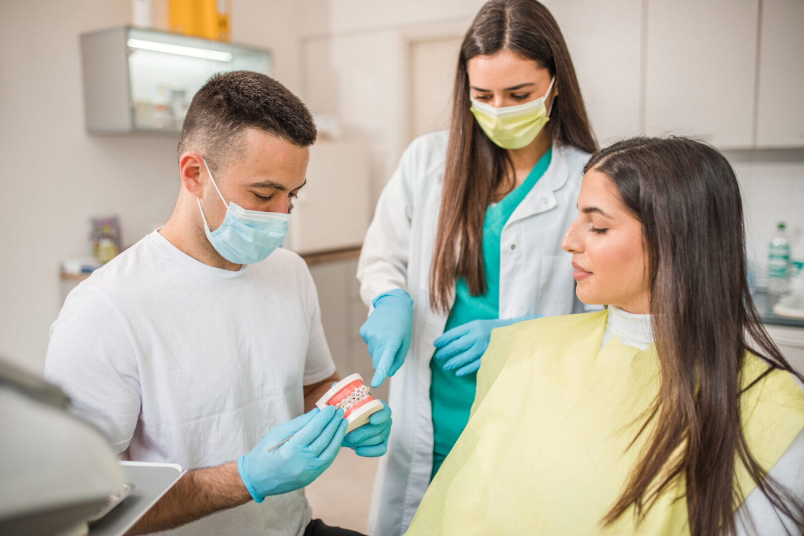 Dentist explaining dental model to patient
