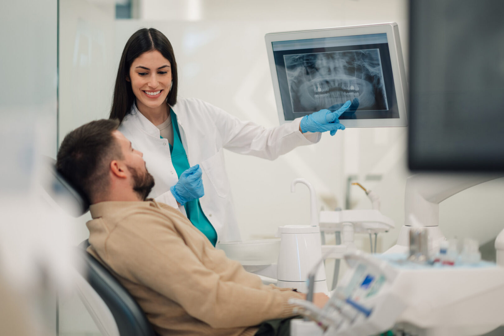 Dentist explaining X-ray to patient.