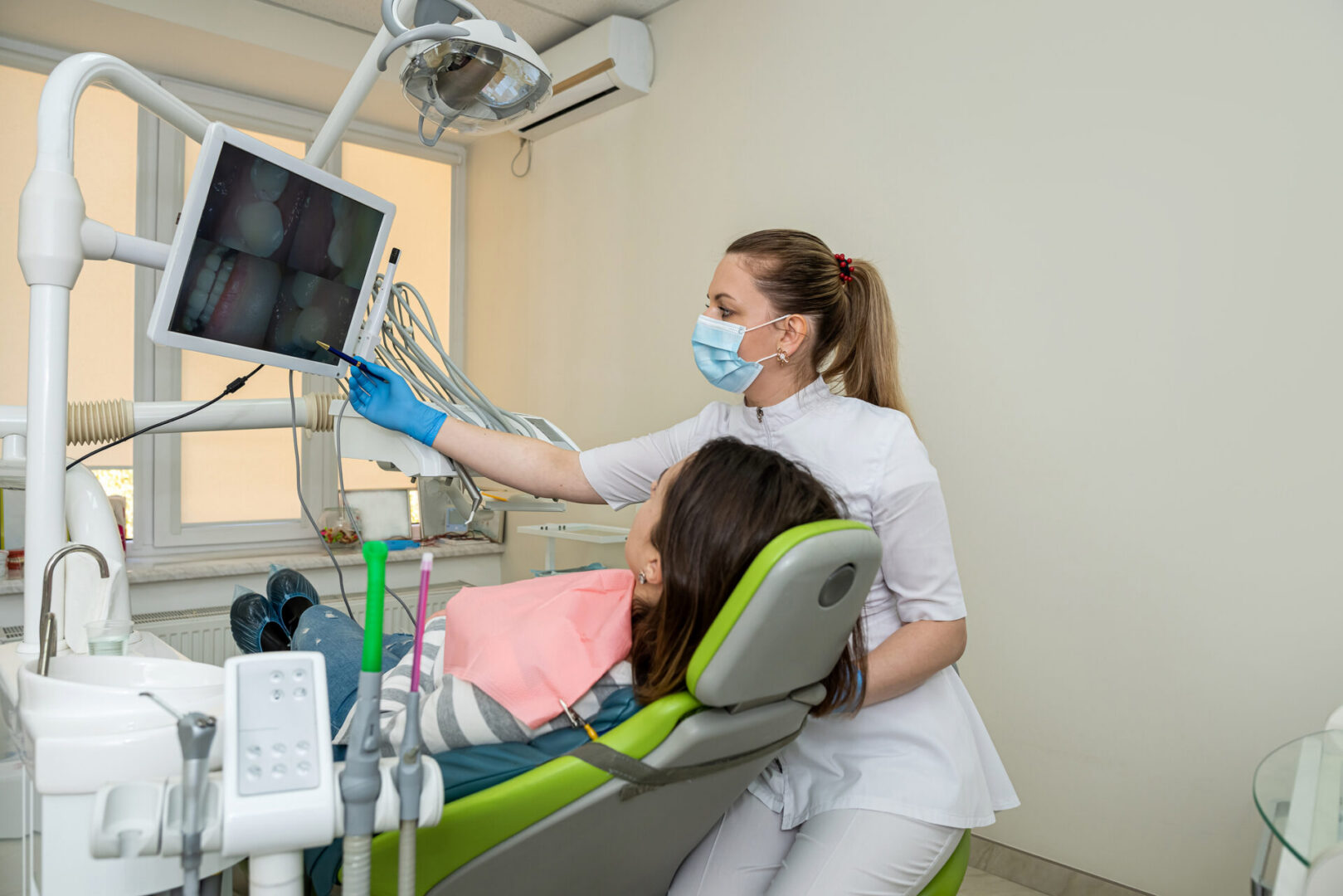 Patient viewing dental X-ray with dentist