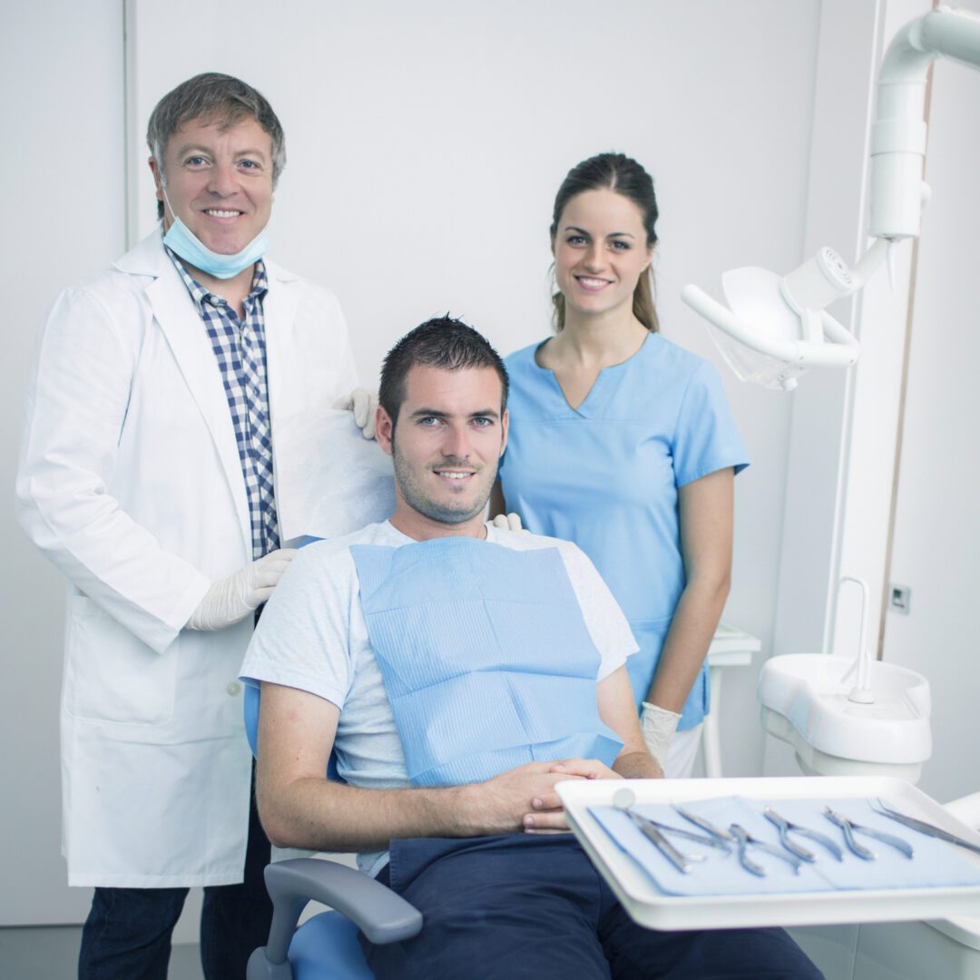 Happy dental team and patient together