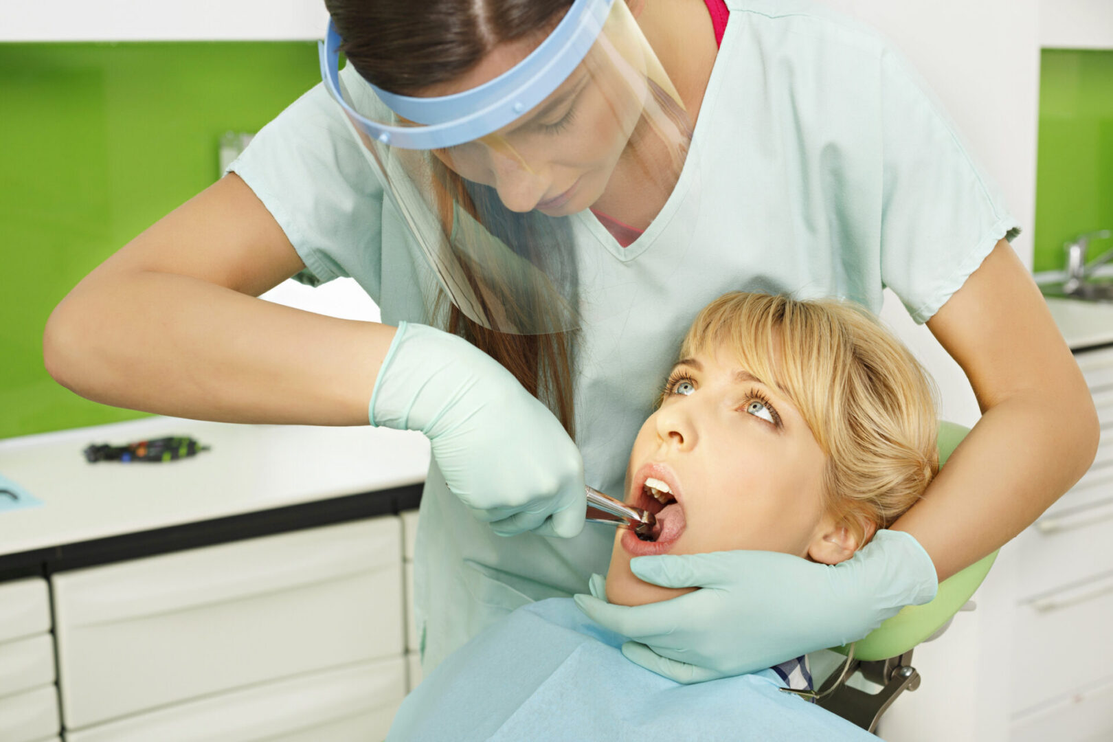 Dentist examining patient's teeth