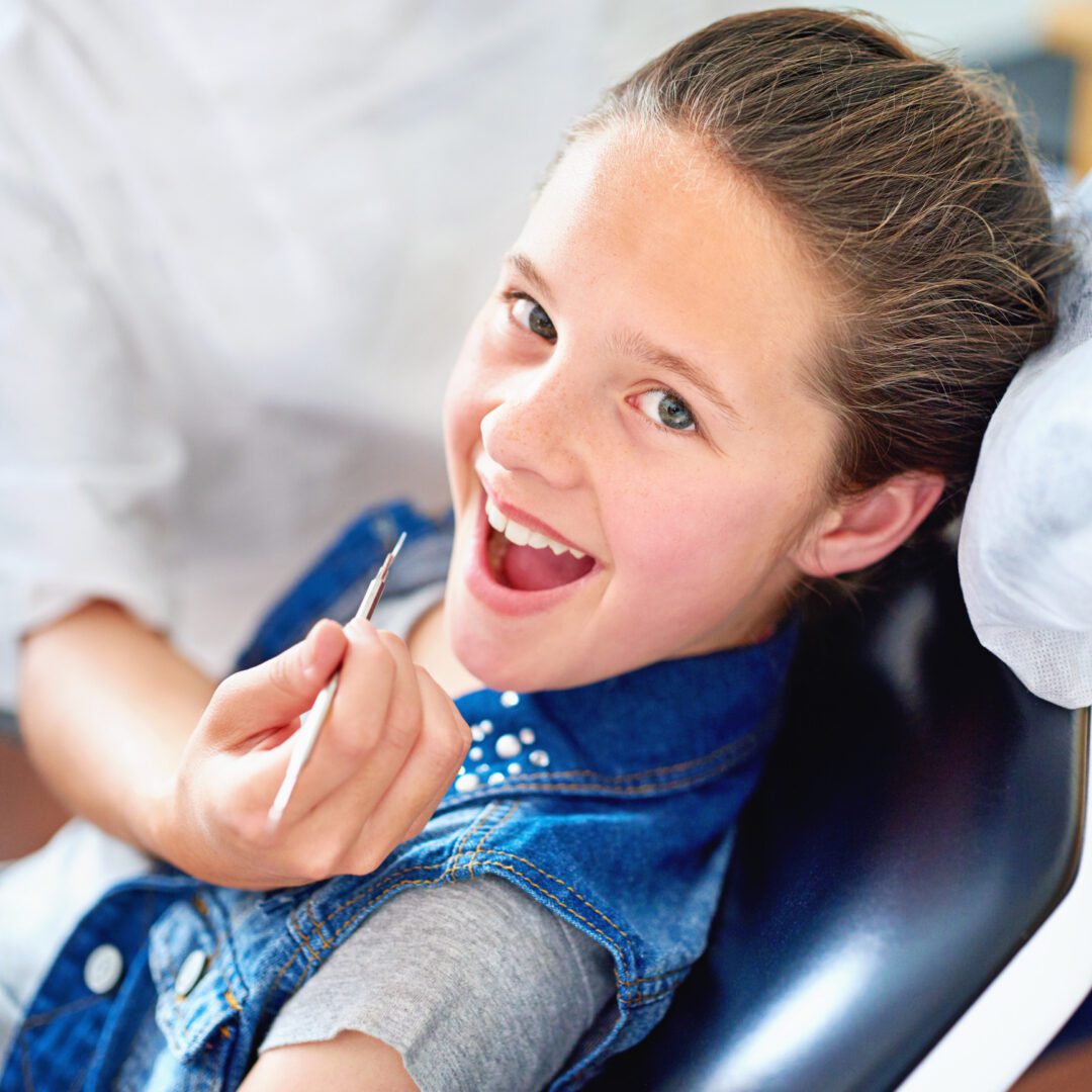 Happy child holding dental tool