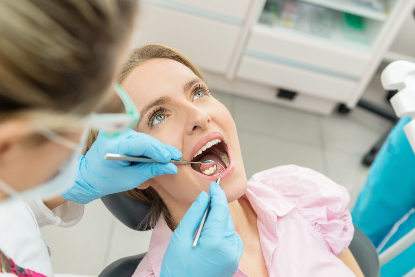 Dentist inspecting woman's teeth