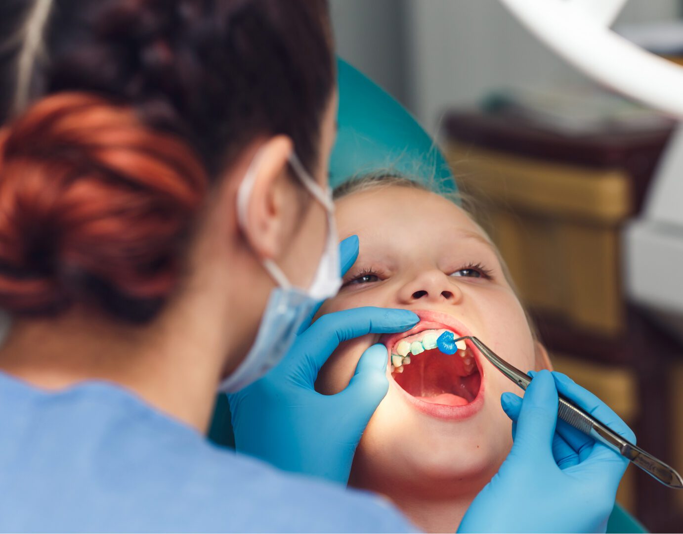 Dentist examining child's teeth