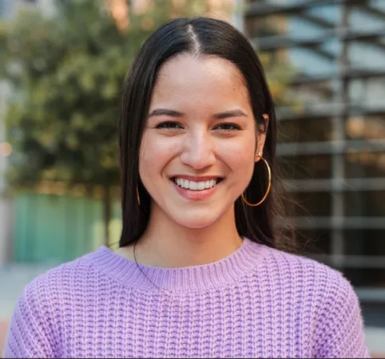 Smiling woman wearing a lavender sweater