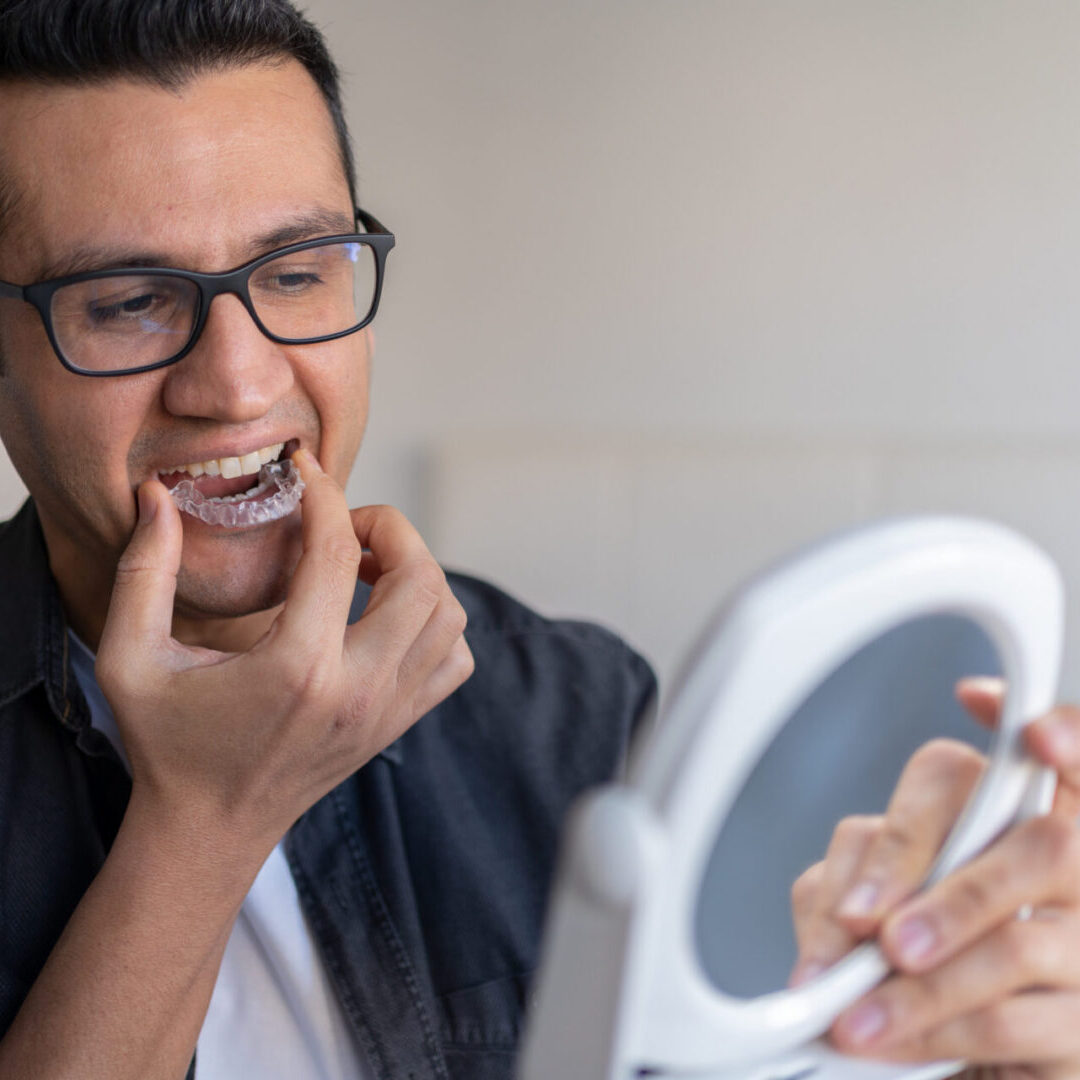 Person using clear aligner for teeth