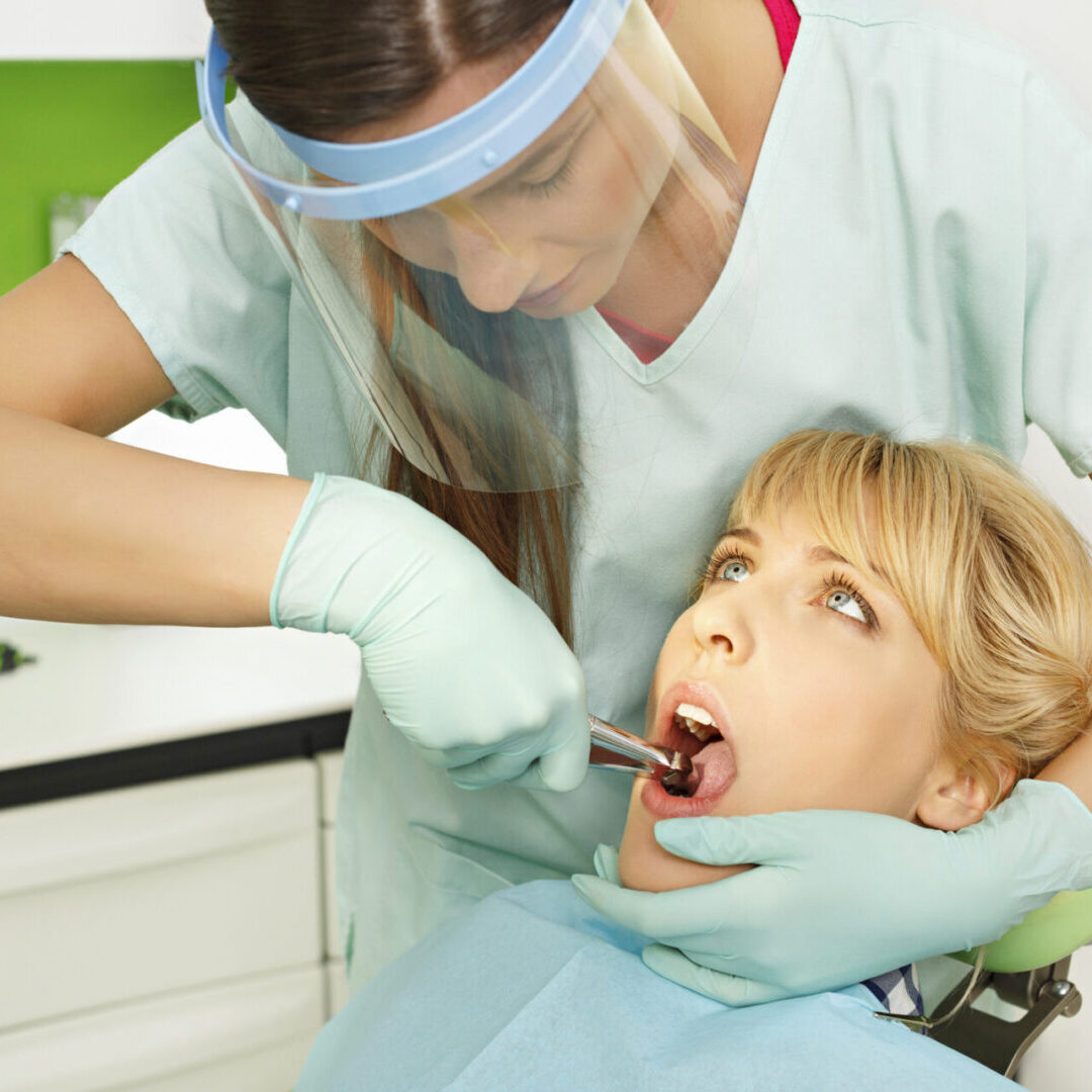 Dentist examining patient's teeth